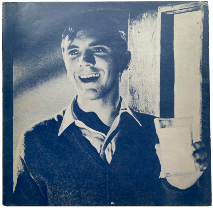 The original front cover for the UK 12" single for "What Difference Does It Make?" After a rights issue regarding the photo—a film still of actor Terrance Stamp—the cover image was replaced by a parody of singer Morrissey in the same pose with a glass of milk.
