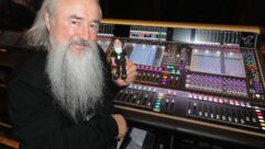 U2's sound director, Joe O'Herlihy, with his DiGiCo SD7 console and a mini doppelganger: “There’s a guy on the crew here that makes them; it’s pretty cool, alright!”