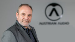 Martin Seidl in front of Austrian Audio logo