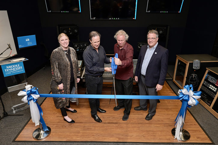 MTSU College of Media and Entertainment Dean Beverly Keel, left, and university Provost Mark Byrnes, right, smile as Department of Recording Industry chair John Merchant, center left, and audio production professor Dan Pfeifer cut a ceremonial ribbon Friday night, Dec. 3, in the control room of Studio D.