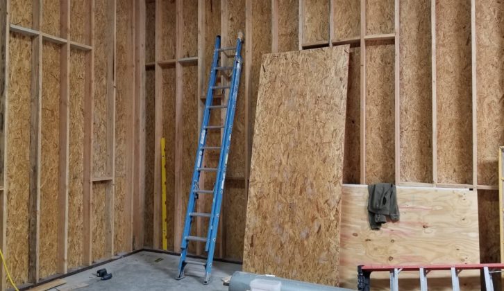 One outer side wall and the outer front wall positioned on the anchor bolts and locked in place. paul massey mix room