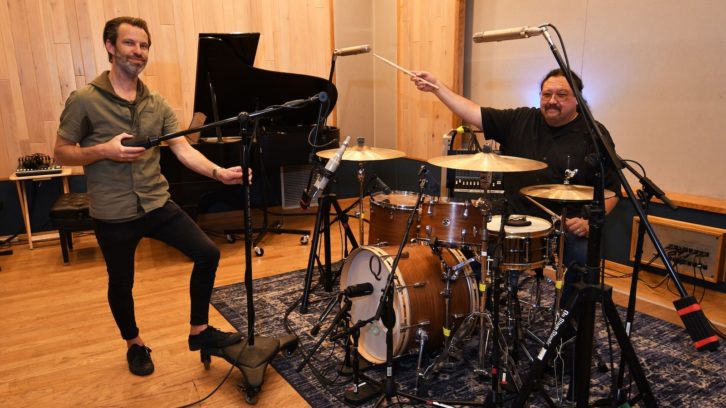 Chief engineer Samuel Madill and studio partner/engineer Lee Bench are seen with a full complement of Telefunken mics on the drum kit. Photo: David Goggin.