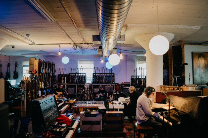 At their stations in The Loft are (L-R): Jeff Tweedy, Nels Cline, Pat Sansone and Mikael Jorgensen. At the far left, engineer Tom Schick’s silhouette can be seen in the “control room.” PHOTO: Jamie Kelter Davis