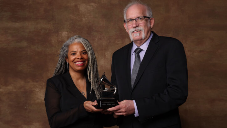 ES President-Elect Leslie Gaston-Bird and AES President Bruce Olson accepted a Technical Grammy Award for the AES.