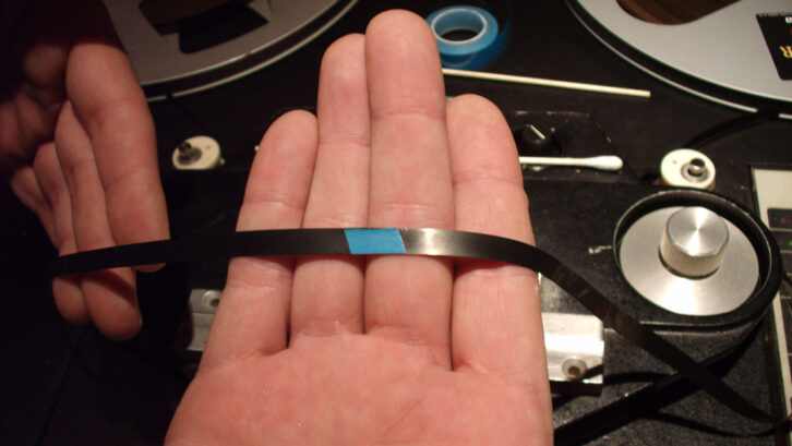 Repairing an edit splice on 2-track analog tape. Photo: Kelly Pribble.