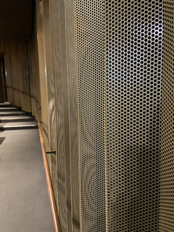 A close-up view of the perforated metal wall panels.