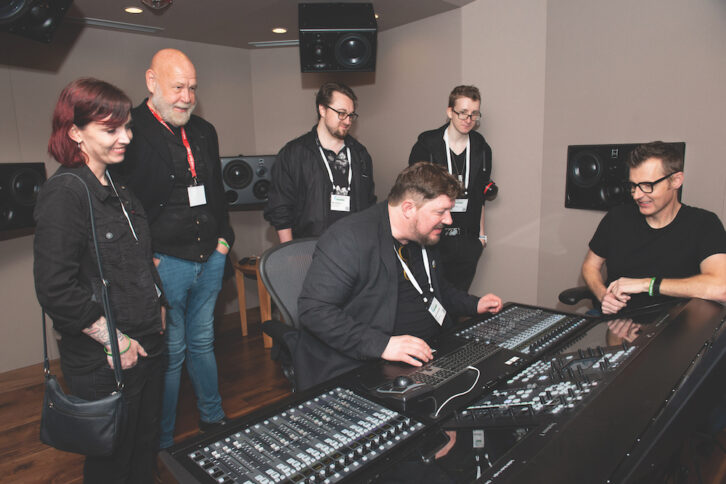 SSL’s Phil Scholes, far right, points out mix features on the SSL System T for Music, at Starstruck Studios’s new ATC 7.1.4 Dolby Atmos mix room.