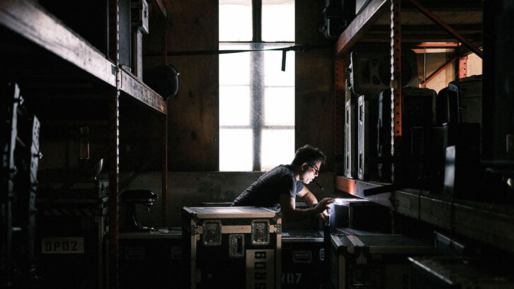 Chris “Sully” Sullivan of L-Acoustics searches for counterfeit L-Acoustics product in the warehouse of Se7ven Sounds Music, Inc during a raid to seize fake products. Photo: Zack Wittman / L-Acoustics.