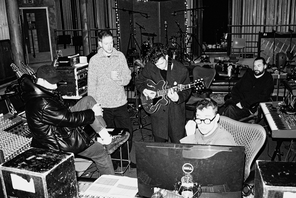 Producer Jack Antonoff (foreground) and The 1975, hard at work in January 2022. Photo: Alex Lockett