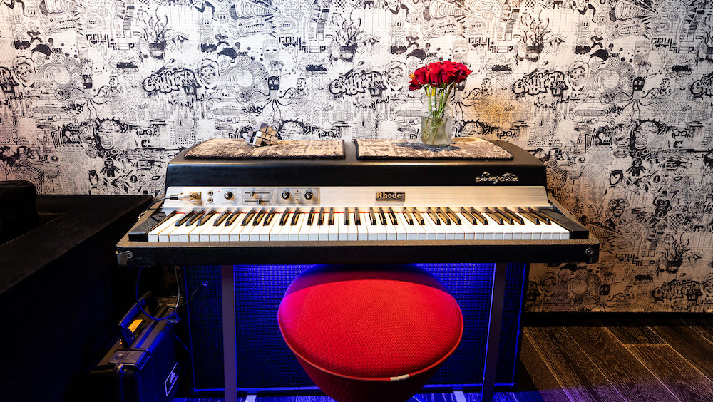 A Fender Rhodes 73-key electric piano in front of the Gaulthier fabric-covered walls.