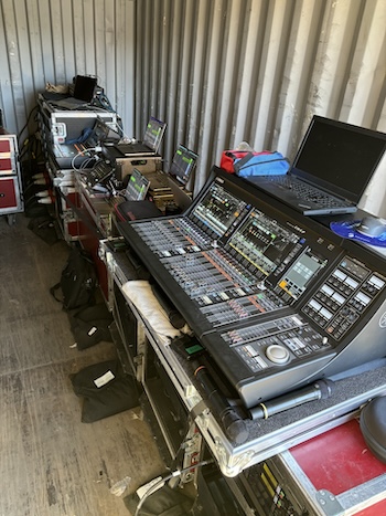 The mix positions inside the shipping container (l-r): Yamaha DM7C for FOH; playback rig; and DM7 for monitors.