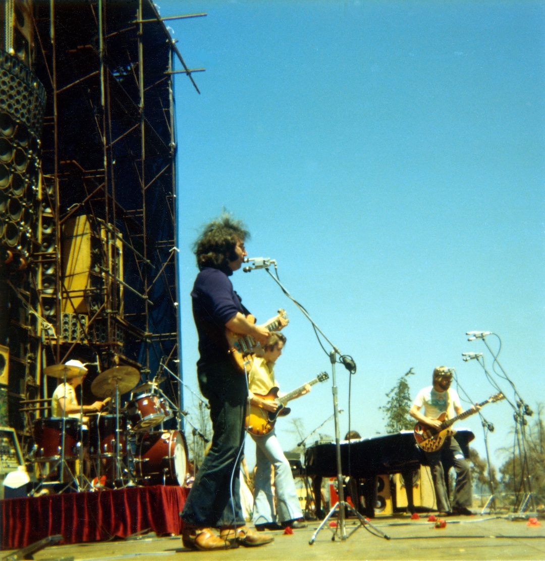 (L-R) Bill Kreutzmann, Jerry Garcia, Bob Weir and Phil Lesh perform on May 25, 1974, at Santa Barbara Stadium in Santa Barbara, California, with the Wall of Sound. Photo: Ed Perlstein/Redferns/Getty Images.