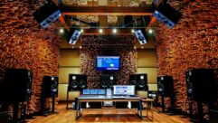 The Dolby Atmos-enabled Blackbird Studio C control room in Nashville. The studio includes an Avid S6 control surface and an array of ATC studio monitors selected by Vintage King integration design and integration manager James Good, with wooden acoustic diffusers lining the walls and ceiling.