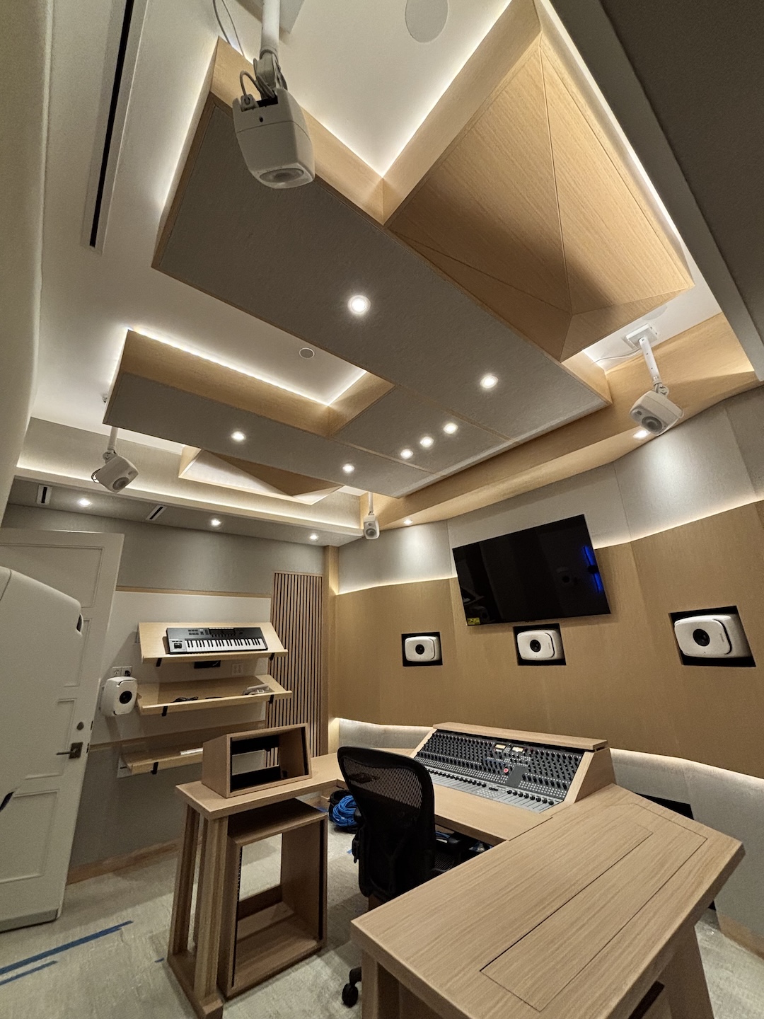 The room features a full 7.1.4 Genelec Atmos system comprised of 8341s for LCR, 8331s for surrounds and 8320s for overheads—all in white per the client’s request.