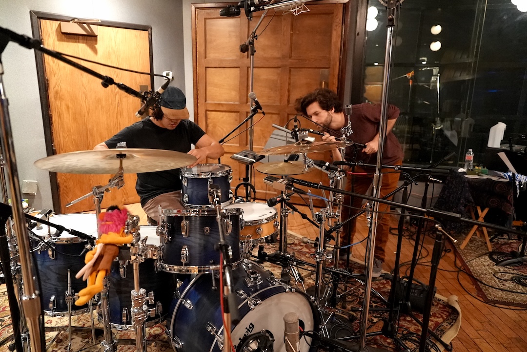 Soroush Rajabnik, who works on Spinal Tap’s tech team, left, and Village assistant engineer Nick Hodges set up the kit.