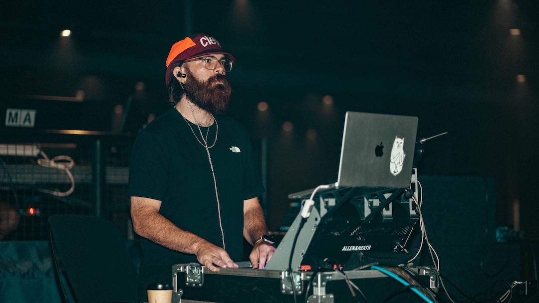 Brent Washburn mans his Allen & Heath dLive C1500 control surface on the road with artist Elijah Woods.