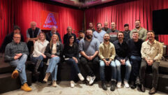 Audio entrepreneur Dirk Ulrich (directly in front of Apogee sign), seen here with company staff, Betty Bennett, co-founder and CEO of Apogee Electronics (center, back row) and Bob Clearmountain (between Bennett and Ulrich), has purchased Apogee Electronics.