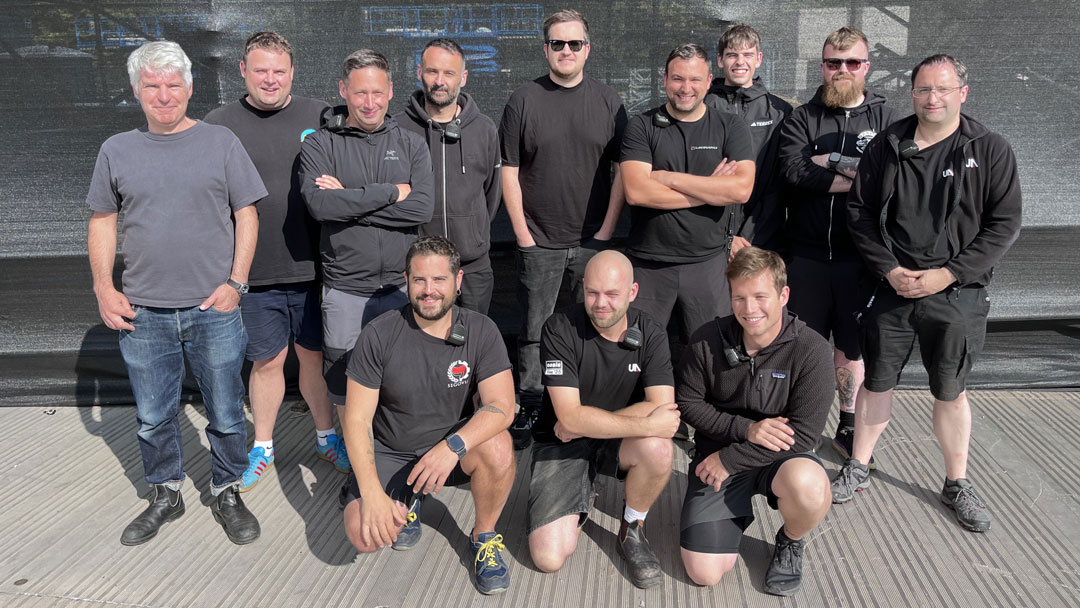 Back Row: FOH Engineer Sam Parker; Liam Gallagher Monitor Engineer, Bertie Hunter; Delay System Engineer, Mark Pantlin; Monitor and Stage Tech, Dan Speed; Noel Gallagher Monitor Engineer, Steve Weall; Systems Engineer, Ben Webb; Delay Tech, William Smith; Monitor and RF Tech, Finlay Watt & FOH Engineer, Dan Lewis. Front Row: Stage Right PA Tech, Victor Calle Gonzalez; FOH Tech, Jake Roberts & Stage Left PA Tech, Claus Köpplin Orrán.