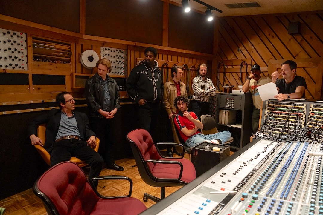 Actor Jeremy Strong (as Jon Landau), at left, with director Scott Cooper (far right) with The E Street Band cast inside Power Station’s Studio A control room.  The room was refitted by the studio’s staff to faithfully reflect the technology of the 1982 recording session being portrayed. Photo: Macall Polay/20th Century Studio.