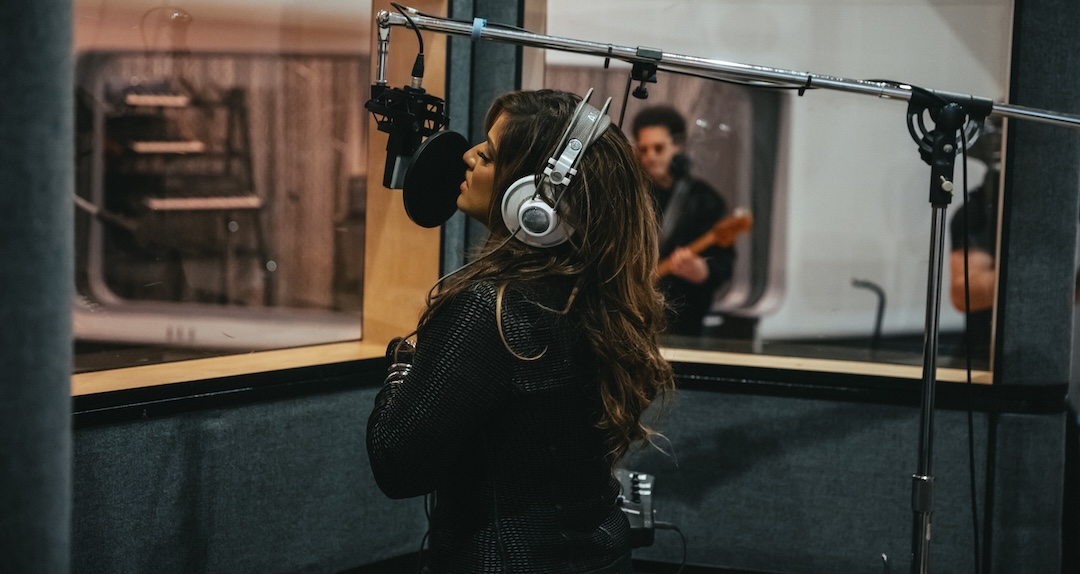 Vocalist Malavika belts into an AKG C Series microphone at the Road to NAMM event. Photo: Harman.