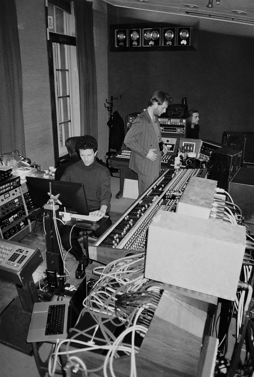 Blue May stands in front of the 1970s API 48-Channel Split record/ monitor console inside London’s RAK Studio 1 during a string session with engineer Ben Baptie seated at the Pro Tools station. Photo: Courtesy of Blue May.