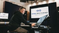 Mastering engineer Adam Ayan seated at his new SPL DMC mastering console, listening out of his Duntech monitors, surrounded by the full-room GiK Acoustics treatment.