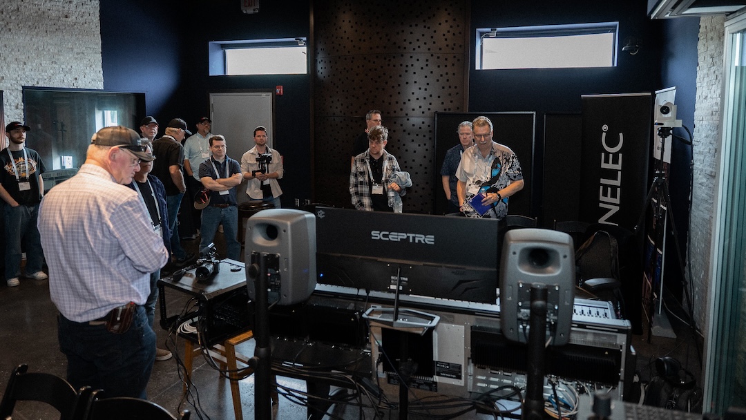Members of the audience surround the SSL Origin evo-Genelec Ones setup during a live tracking session. Separate SSL Oracle-Genelec Ones and Harrison 32Classic-Genelec Ones stations allowed attendees to walk around, sit in the sweet spot and compare the three in real time. Photo: Future/Kevin Craig