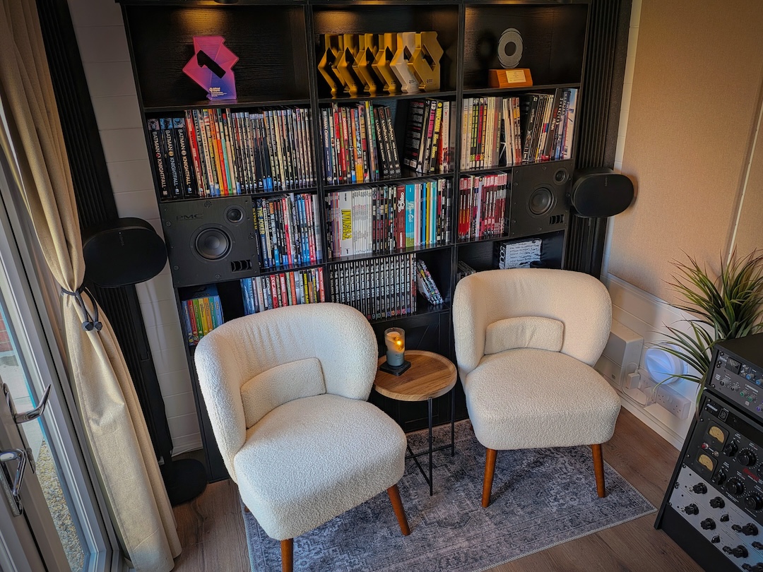 The back wall of the room is festooned with awards and prized graphic novels.