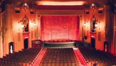 Alcons Audio speakers are discreetly placed on either side of the stage beneath the hanging lanterns.