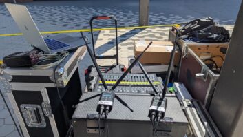RF Venue’s RF PA Extension Kit, the receiver pair shown here atop the transmitter at the mix position during set-up, wirelessly delivered audio through the deployed receivers to powered speakers covering the graduate processional lineup at UMass Boston