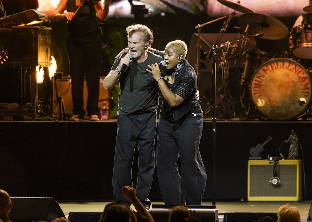 Multi-instrumentalist Crystal Taliefero, seen here belting “Wild Night” with Mellencamp, got her professional start when he discovered her playing a Bloomington, Ind., bar in 1985. Photo: Scott Legato/Getty Images for Live Nation
