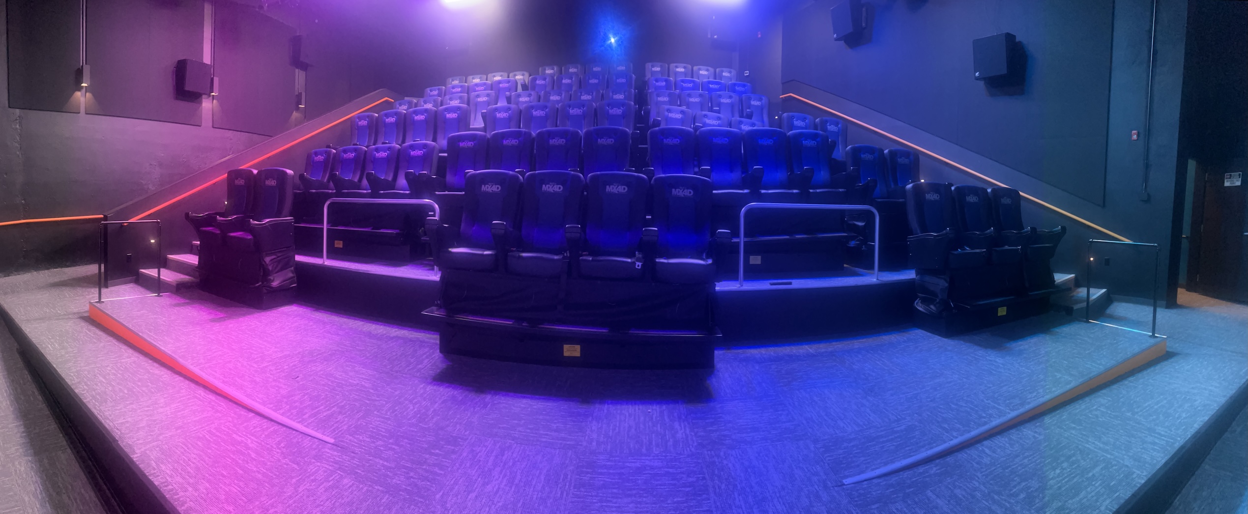 A curvilinear view from the curved screen, looking out at the special motion control seats, which can move and vibrate for a “4D” experience. Photo: Courtesy of Rick Camp